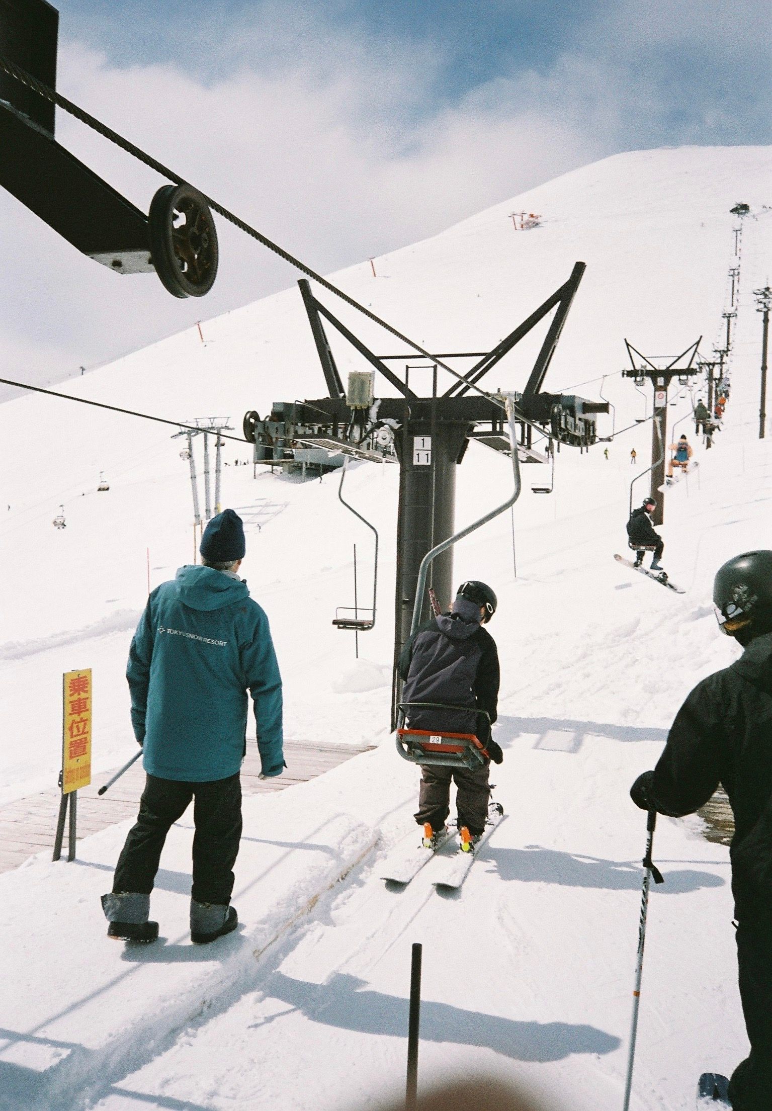 Skier getting on the pizza box chairlift in Niseko