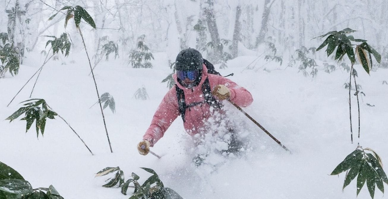 Skiers carving fresh powder in Rusutsu