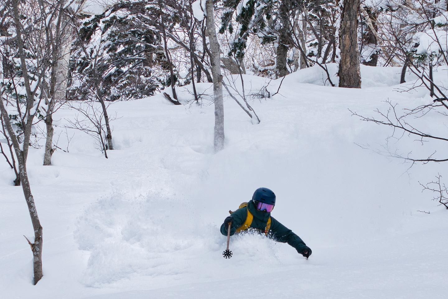 A skier deep in powder snow in Kiroro